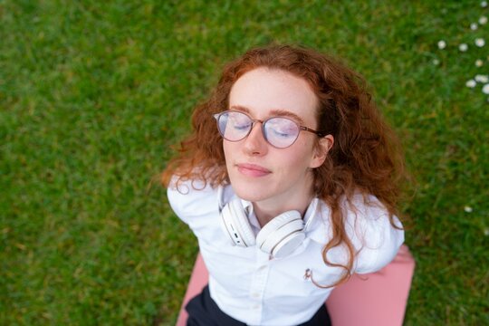 Woman lying on grass looking up