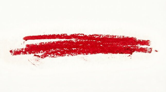 Vibrant red lipstick smudge on textured white background representing cosmetic product testing.