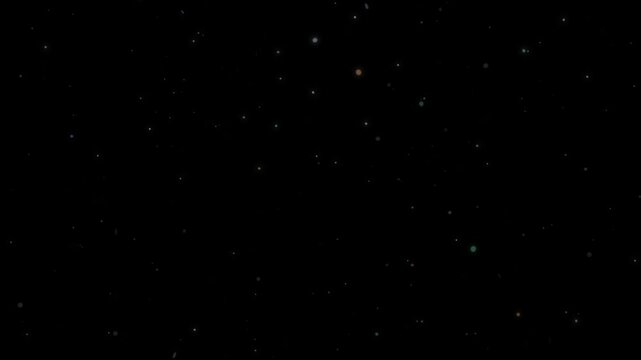 Subtle colorful small particles gently float up like dust or ash against a dark background motion effect