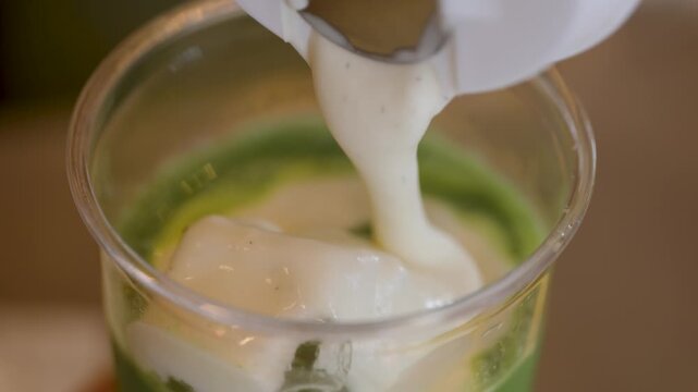 Close up of vanilla cream top on iced matcha drink