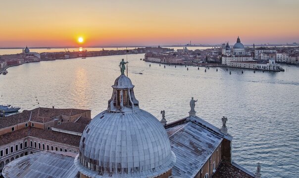 Sunset over the Giudecca Canal with the churches of San Giorgio Maggiore and Santa Maria della Salute, Venice, Veneto, Northern Italy, Italy. UNESCO World Heritage Site