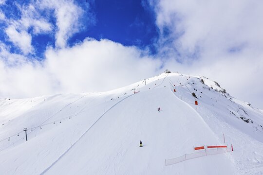 Skiers in the ski area at the summit of Corne de Sorebois, Val d'Anniviers, Valais Alps, Canton Valais, Switzerland