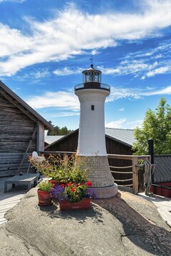 Small lighthouse decorated with flowers, K&auml;ringsund fishing village, Fasta &Aring;land, Aland Islands, Aland Islands, Finland
