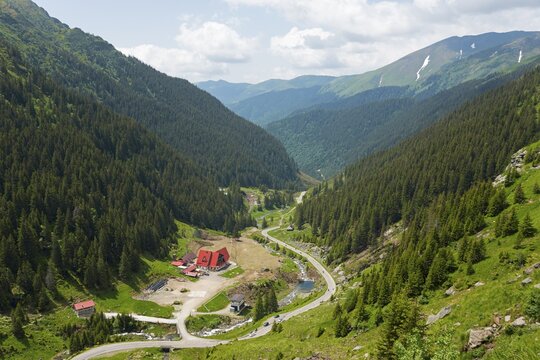 A green mountain valley with a river and a road, surrounded by dense forests, mountain road, Capra River, Transfogarasan High Road, Transfagarasan, Transfăgărășan, Făgăraș Mountains, Fagaras, Transylvania, Transylvania, Transylvania, Ardeal, Transilvania, Carpathians, Romania