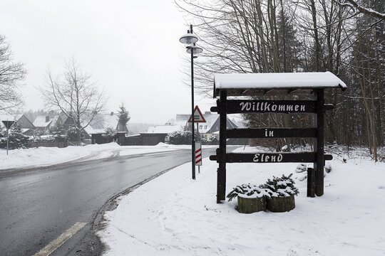 Welcome sign made of wood at the entrance of the village, Welcome to Elend, dreary winter weather, district Elend, Oberharz am Brocken, district Harz, Saxony-Anhalt, Germany