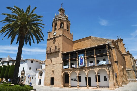 Historic church with bell tower and palm trees under a bright blue sky, Church, once a Moorish mosque, Iglesia de Santa Maria la Mayor, Old Town, Ronda, Malaga, Province of M&aacute;laga, Andalusia, Spain