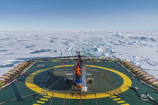 Helicopter on the Helipad of the Icebreaker "50 years of victory" on its way to the North Pole breaking through the ice, Arctic