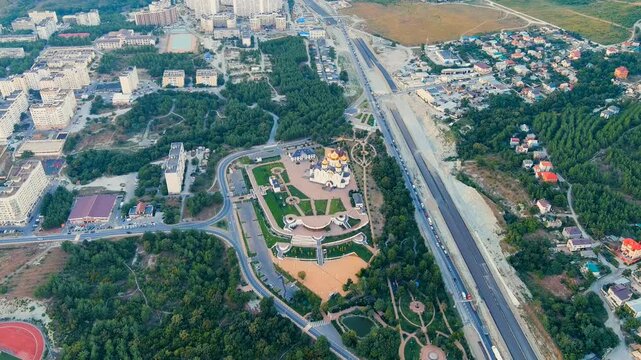 Gelendzhik, Russia. Cathedral of St. Andrew the First-Called, white-stone Vladimir-Suzdal style with gilded domes, Drone footage over Andreevsky park and the M4 highway. Drone footage