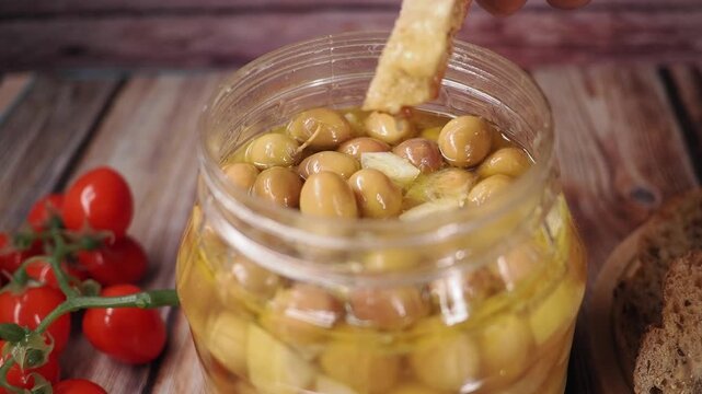 Enjoying olive dip with bread and cherry tomatoes