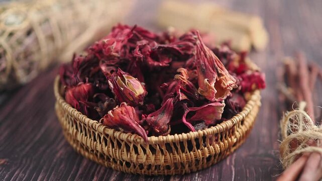 Preparing dried hibiscus in a basket for tea