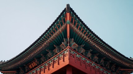 Fototapeta premium Ancient East Asian architecture temple roof wooden beams brackets heritage building with ornate balcony colorful structure and traditional craftsmanship against blue sky