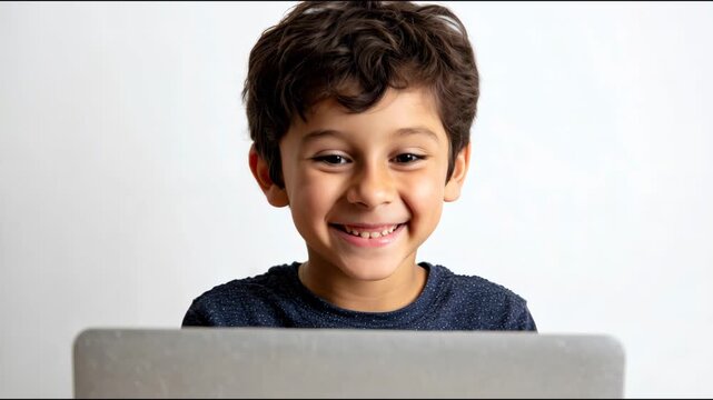 Expressive young boy reacting with surprise and joy while using a laptop on a white background