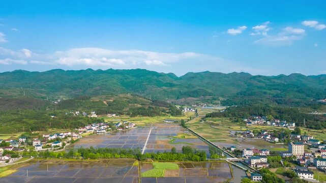 Aerial view of rural village, rice fields and mountain landscape