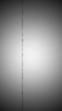Vertical vintage old film texture with scratches, dust, grain, and flicker as retro cinematic overlay background, for creating an aged analog look in professional video projects.

