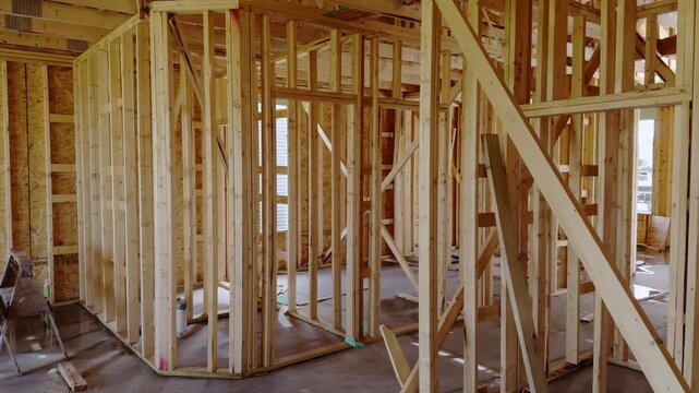 Wood framing inside a new residential house under construction with unfinished walls and structural support beams