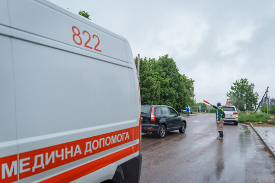 An ambulance van parked on the roadside during a cycling competition accident outdoors, emergency medical assistance, first aid services, road safety.