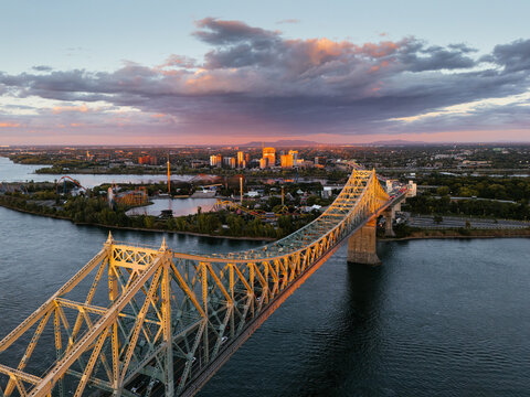 Jacques Cartier Bridge at sunset over Saint Lawrence River, Montreal, Quebec, Canada. g.