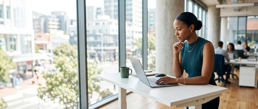 Focused businesswoman working at standing desk, executive decision making, professional productivity, strategic thinking, modern workplace, corporate leadership, digital workflow, copy space
