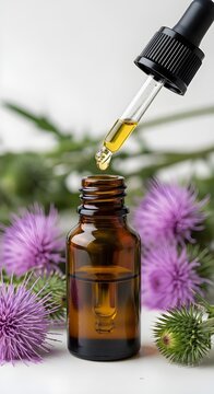 Milk thistle oil dropper bottle with fresh flowers natural health supplement and wellness concept
