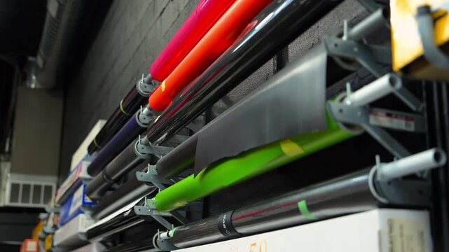 Professional automotive wrap shop with film rolls for applying protective and colored vinyl wrap