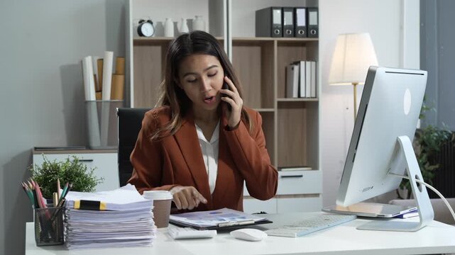 Young Asian woman in suit works confidently in office as business consultant, providing strategic advice, analyzing market trends, financial stability for corporate clients and organizations.