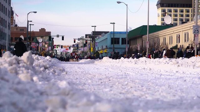 Slow motion dog sled team racing through the snow