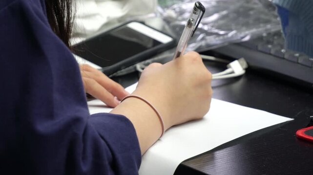Woman Using Computer Mouse at Office Desk with Paperwork