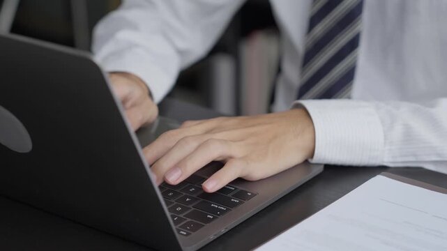Lawyer typing on laptop doing Legal documents