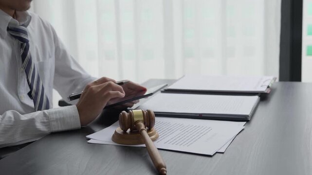 Lawyer using tablet checking legal document in office room