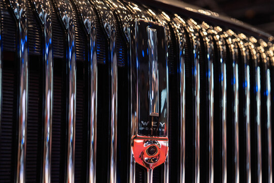 Penang, Malaysia - May 02, 2026: A detailed close-up shot of the massive vertical chrome waterfall front grille of a GWM Wey G9 Hi4 PHEV luxury MPV in a showroom.