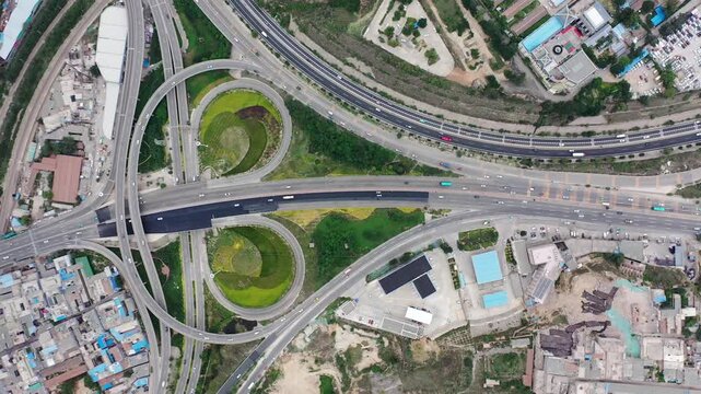 Aerial View of Urban Highway Interchange with Loop Ramps and Traffic