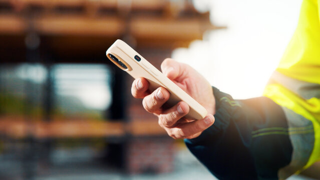 Construction, review or hands on site with phone, task instruction or inspection report in online chat. Space, person or engineer with tech, project brief or operations planning on digital platform.