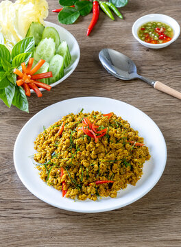 Southern Stir-Fried Pork with Yellow Curry Paste, Thai Southern Style Spicy Minced Pork, Kua Kling Moo, served with assorted fresh vegetables Thai food