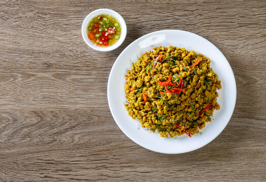 Southern Stir-Fried Pork with Yellow Curry Paste, Thai Southern Style Spicy Minced Pork, Kua Kling Moo, served with assorted fresh vegetables Thai food