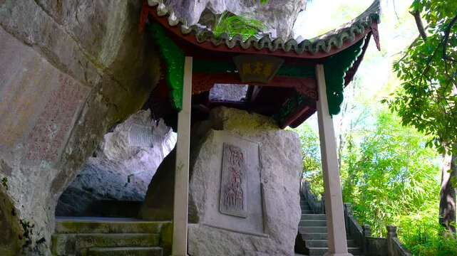 Traditional Chinese Pavilion and Ancient Stone Inscriptions in Cliffside Grotto