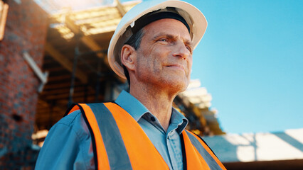 Fototapeta premium Construction, thinking and man with smile on site for building progress, property vision and space. Foreman, mature person or reflection outdoor for development, quality control or project management
