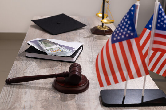 Wooden judge gavel close up on desk table surface with office documents