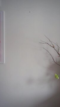 Young woman hanging a framed picture on a wall