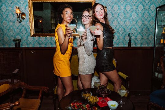 Three diverse friends enjoying a party night celebration