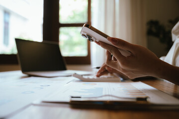 Fototapeta premium Business professional analyzing financial reports on a tablet and laptop dashboard, reviewing performance metrics, budgeting, and business data for strategic decision-making.