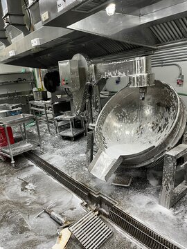 Food processing equipment being cleaned with foaming detergent after production. Industrial sanitation procedure supporting food safety, hygiene control, and contamination prevention in a food manufac