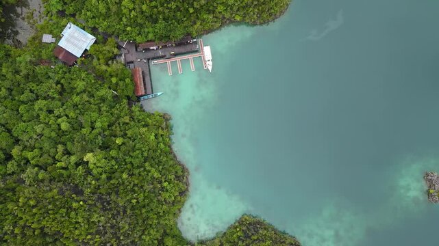 Aerial view of tropical limestone karst islands surrounded by crystal clear turquoise water in Raja Ampat