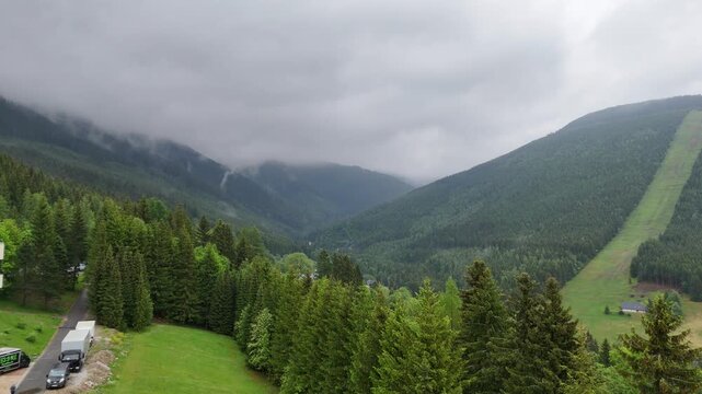 Aerial view of mountain house in misty spruce forest in Krkono&scaron;e Mountains Czech Republic