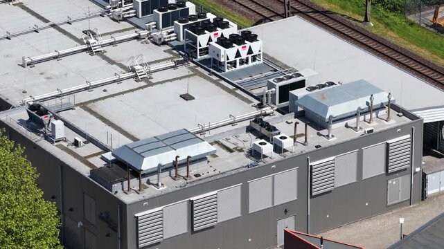 Aerial view of HVAC systems on the roof of a commercial datacenter, showing cooling units, ventilation, thermal management, and reliable server infrastructure.