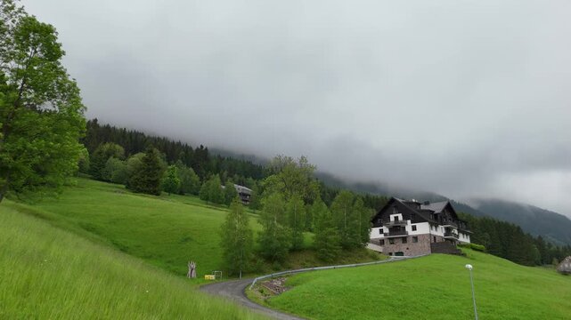 Aerial view of mountain house in misty spruce forest in Krkono&scaron;e Mountains Czech Republic