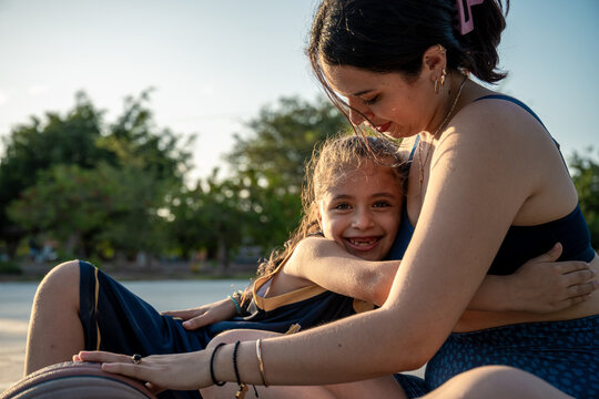 Mother and daughter sharing an affectionate moment outdoors