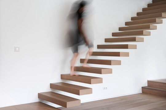 Germany, Cologne, Woman on stairs