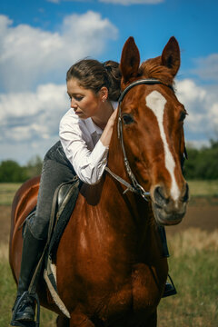 Woman on horse, looking away, sunny day, outdoor