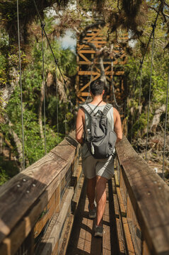 Man with backpack hikes on wooden bridge at Myakka River State Park