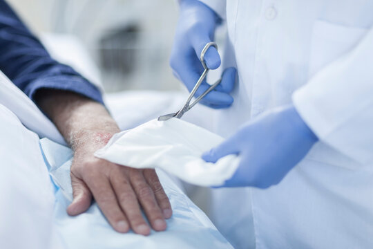 Nurse cleaning patient hand from IV drip